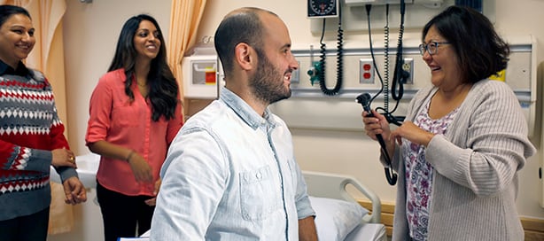 nursing students examine a patient
