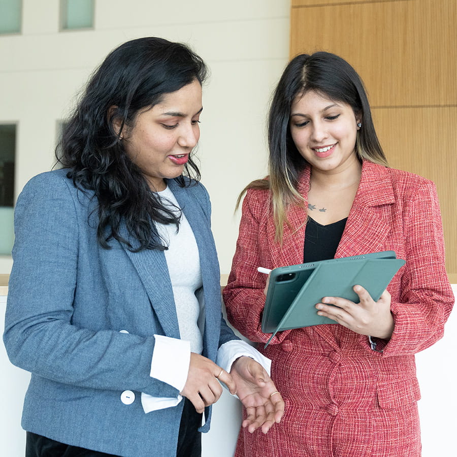 2 professional females with tablet