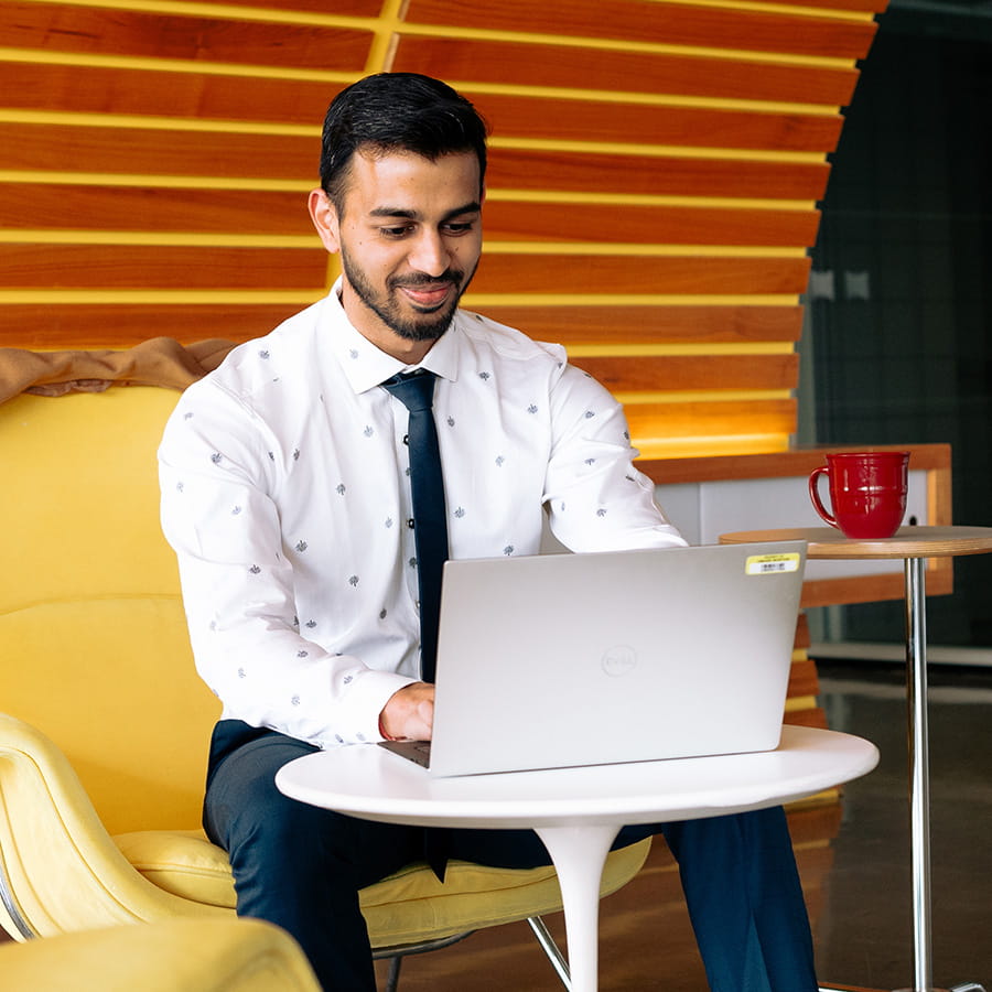 Male professional sitting and working on laptop