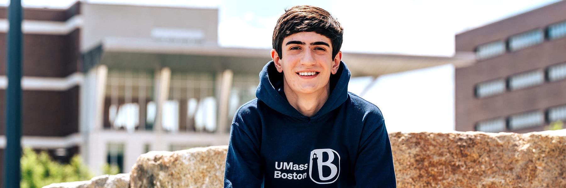 Student wearing UMB sweatshirt in Quad
