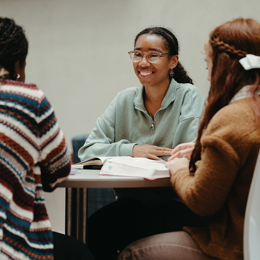 group students studies in campus center at a table.