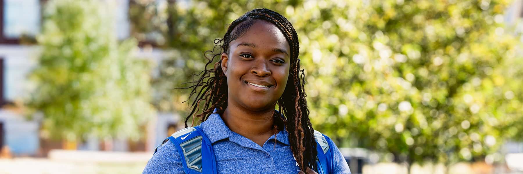 Female UMass Boston student looking at camera